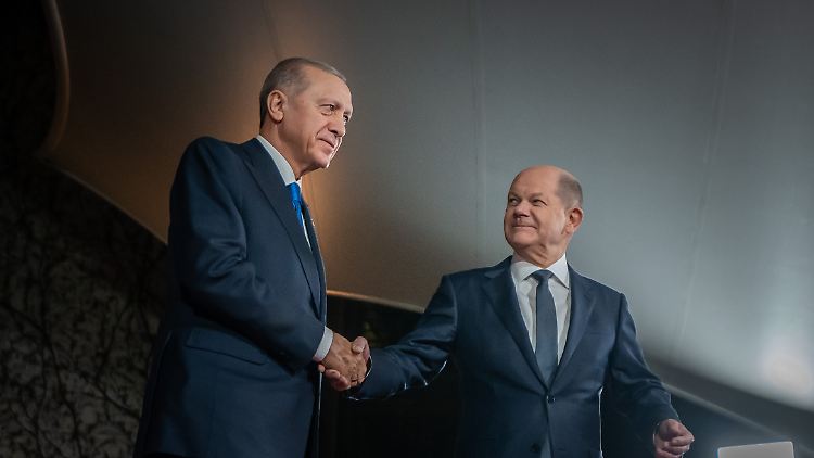 "Der Andere" gibt dem türkischen Staatschef die Hand.