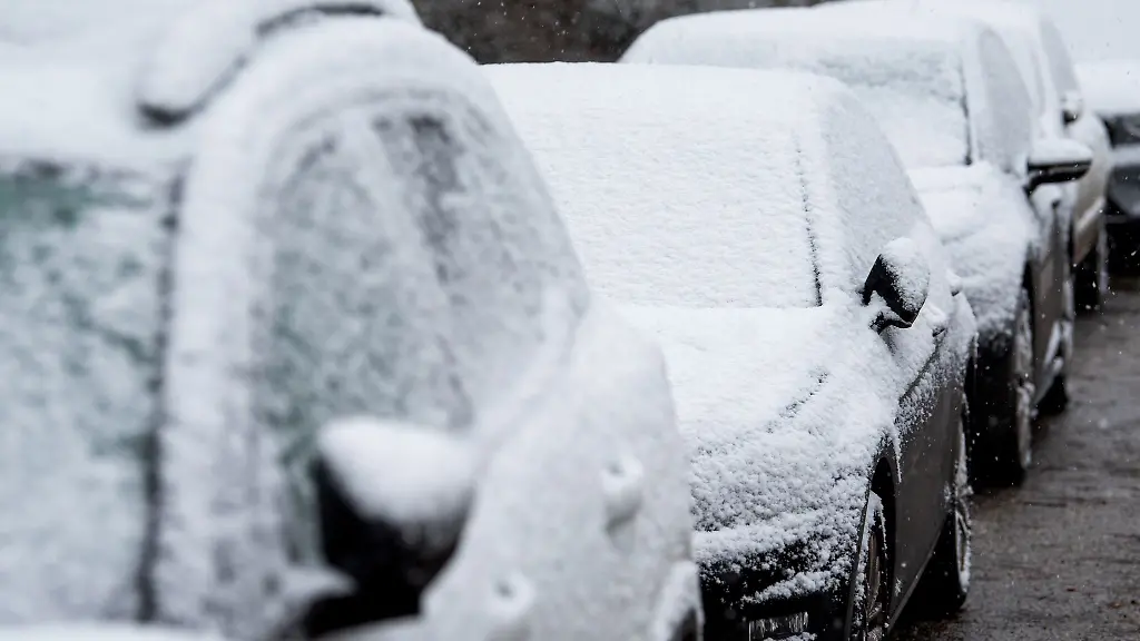 Schnee-liegt-am-Morgen-auf-geparkten-Autos