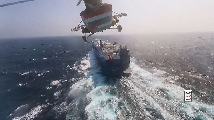 Ein Hubschrauber der Huthi-Rebellen fliegt über ein Frachtschiff im Roten Meer.