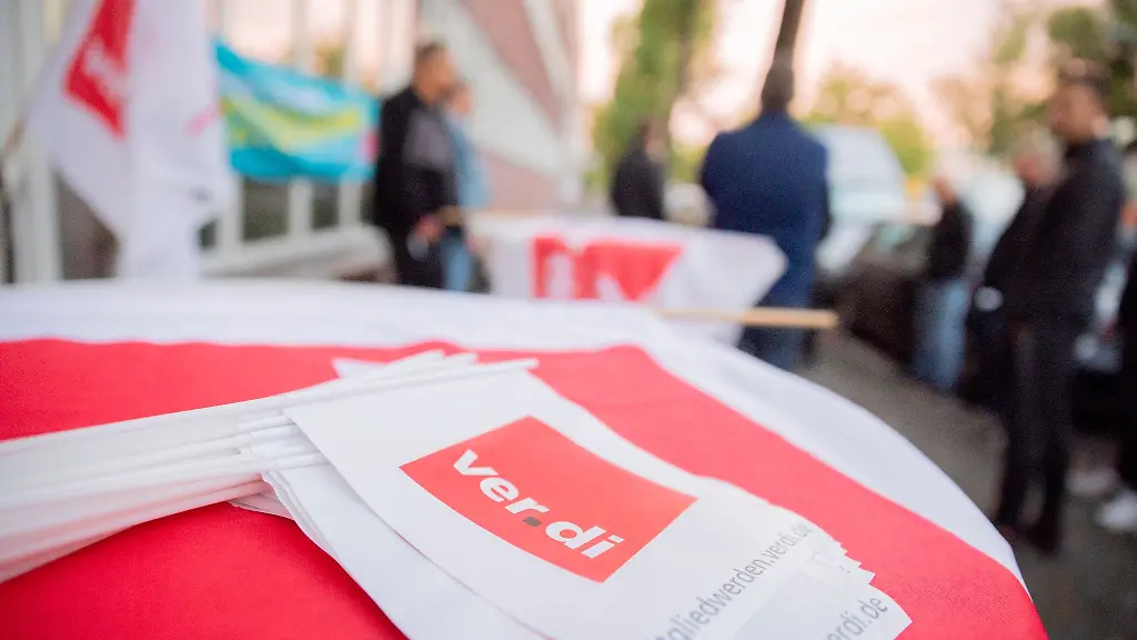 Faehnchen-mit-dem-Logo-von-Verdi-liegen-bei-einem-Warnstreik-auf-einem-Tisch