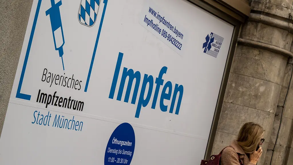 Ein-Plakat-mit-der-Aufschrift-Impfen-klebt-im-Fenster-eines-Impfzentrums-im-Rathaus