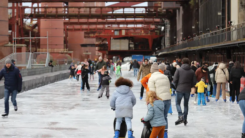 Eislaeufer-fahren-auf-der-Eisbahn-am-Zollverein