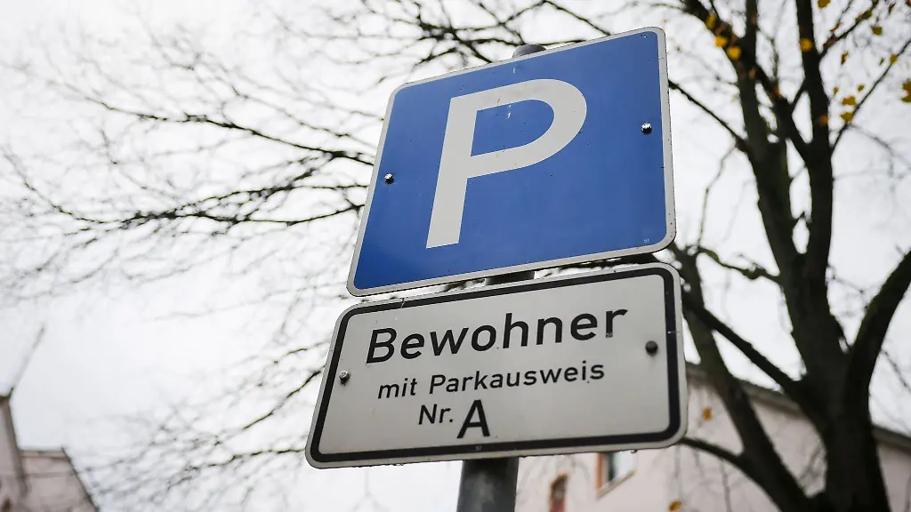 Ein-Parkschild-steht-an-einer-Strasse-mit-Parkplaetzen-fuer-Bewohner-mit-Parkausweis