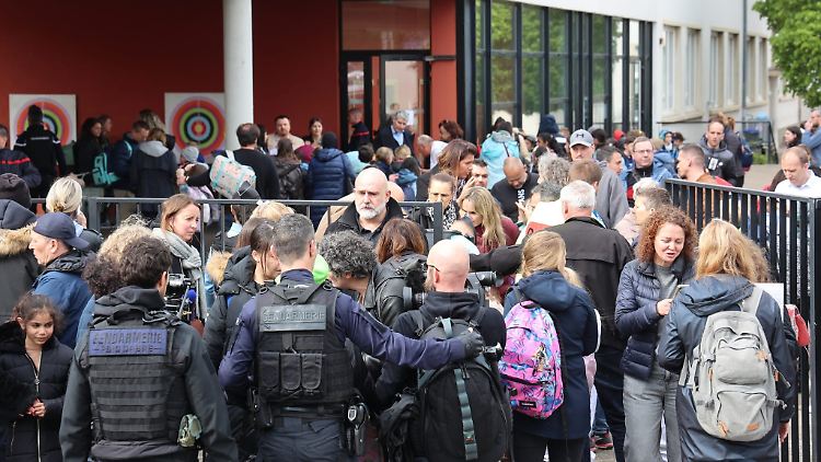 Polizisten schirmen den Schulhof ab.