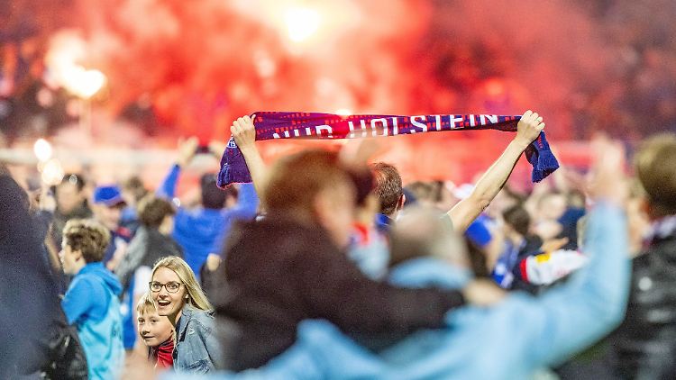 Kieler Fans feiern den Aufstieg nach dem Platzsturm.