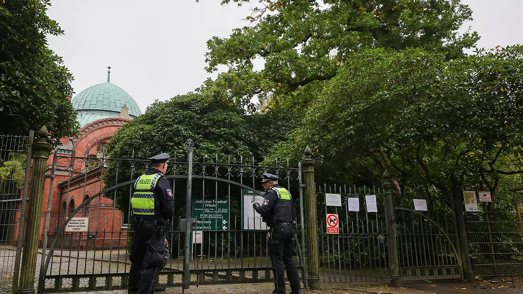 Zwei-Streifenbeamte-sprechen-am-juedischen-Friedhof-in-Hamburg-Ohlsdorf-mit-einem-Friedhofsmitarbeiter