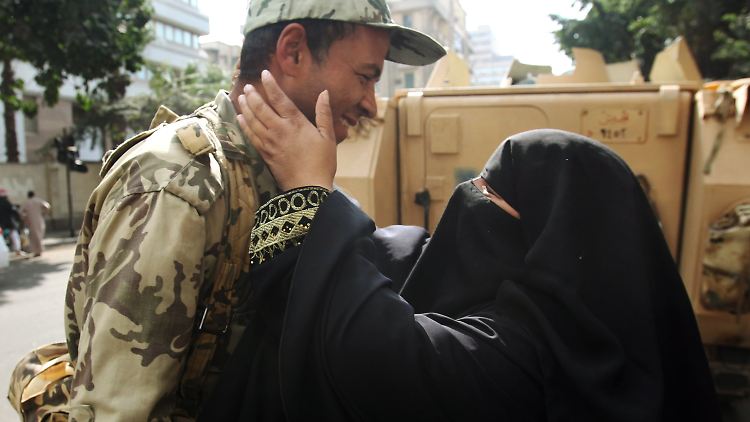 Friedlich, Seite an Seite: Eine ägyptische Mutter umarmt ihren Sohn, der in der Armee dient. Die Militärführung hatte ihre Zurückhaltung bekannt gegeben.