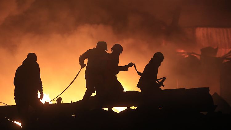 Feuerwehrleute löschen ein Feuer, das durch einen israelischen Luftangriff verursacht wurde.