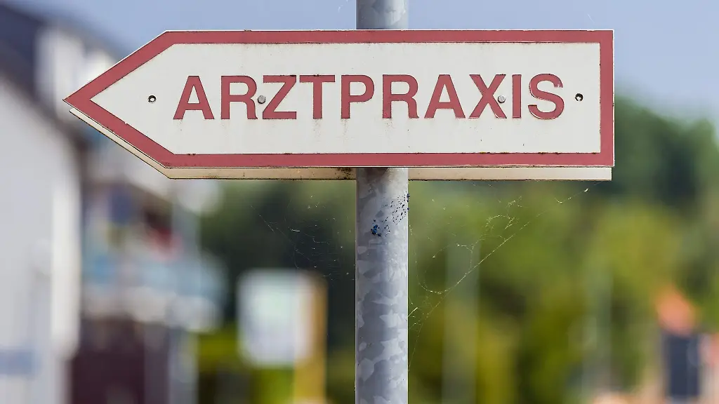 Ein-Schild-Arztpraxis-steht-an-der-Strasse