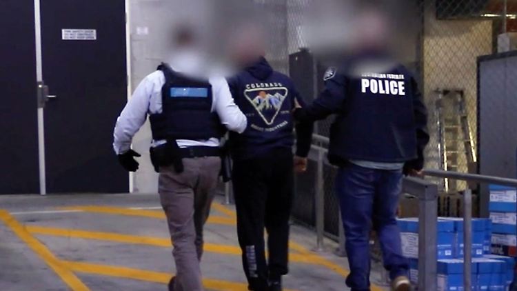 Die australische Polizei führt den 62-jährigen Verdächtigen ab.