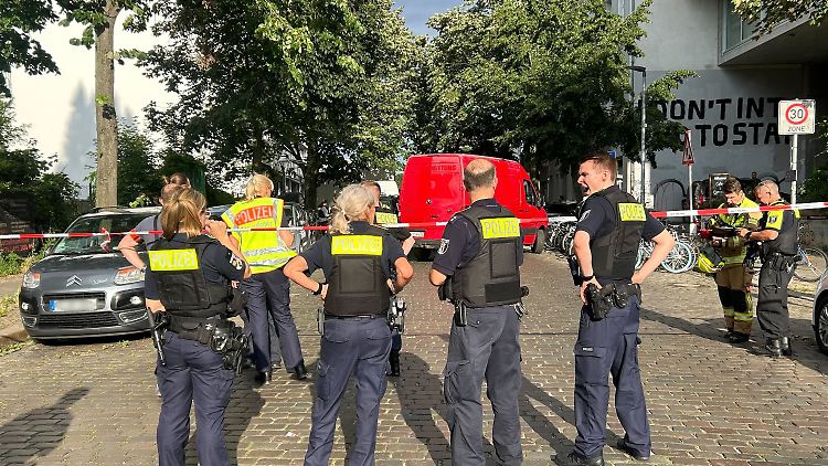 Einsatzkräfte der Polizei stehen am Tatort - nachts zuvor waren es noch deutlich mehr.
