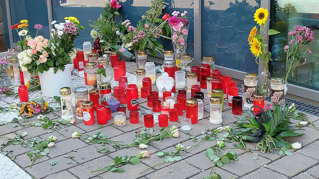 Blumen-und-Trauerkerzen-erinnern-an-die-30-Jahre-alte-Frau-die-hier-bei-einem-Messerangriff-von-einem-psychisch-kranken-Mann-getoetet-wurde