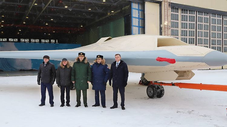 Russische Offizielle vor einem Prototyp der S-70 Ende 2021. 