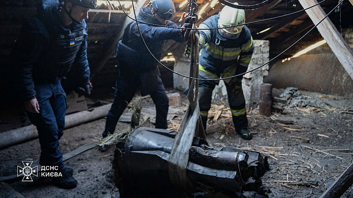 In Kiew entfernen Rettungskräfte einen Teil einer Rakete, die in ein Wohnhaus eingeschlagen ist.