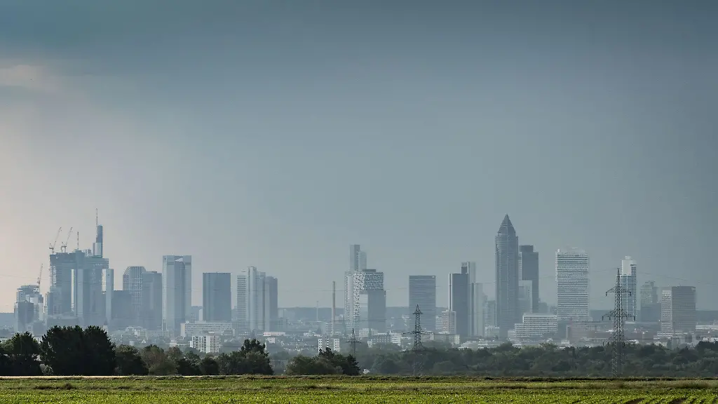 Ein-Gewitter-zieht-am-Vormittag-ueber-die-Frankfurter-Bankentuerme-hinweg-waehrend-sich-links-schon-wieder-besseres-Wetter-ankuendigt