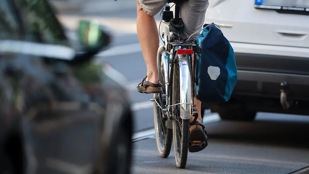 Ein-Radfahrer-schlaengelt-sich-zwischen-Autos-hindurch