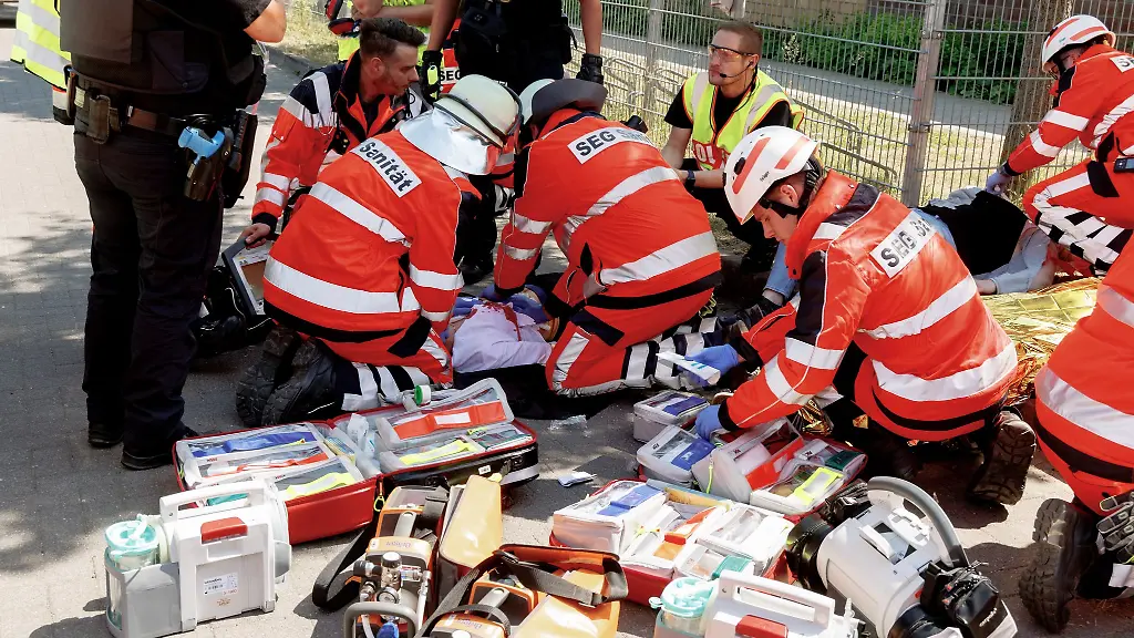 Sanitaeter-versorgen-bei-einer-Uebung-die-eine-Amoklage-in-einer-Schule-simuliert-eine-Statistin-die-eine-verletzte-Schuelerin-darstellt