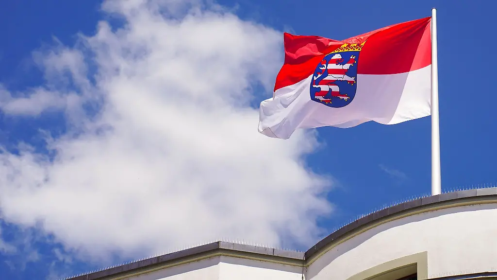 Die-hessische-Landesfahne-weht-auf-dem-Dach-des-hessischen-Landtages-vor-dem-Sommerhimmel