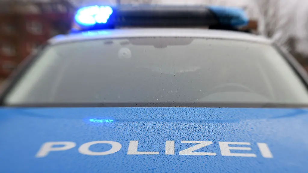 Ein-Streifenwagen-der-Polizei-steht-mit-eingeschaltetem-Blaulicht
