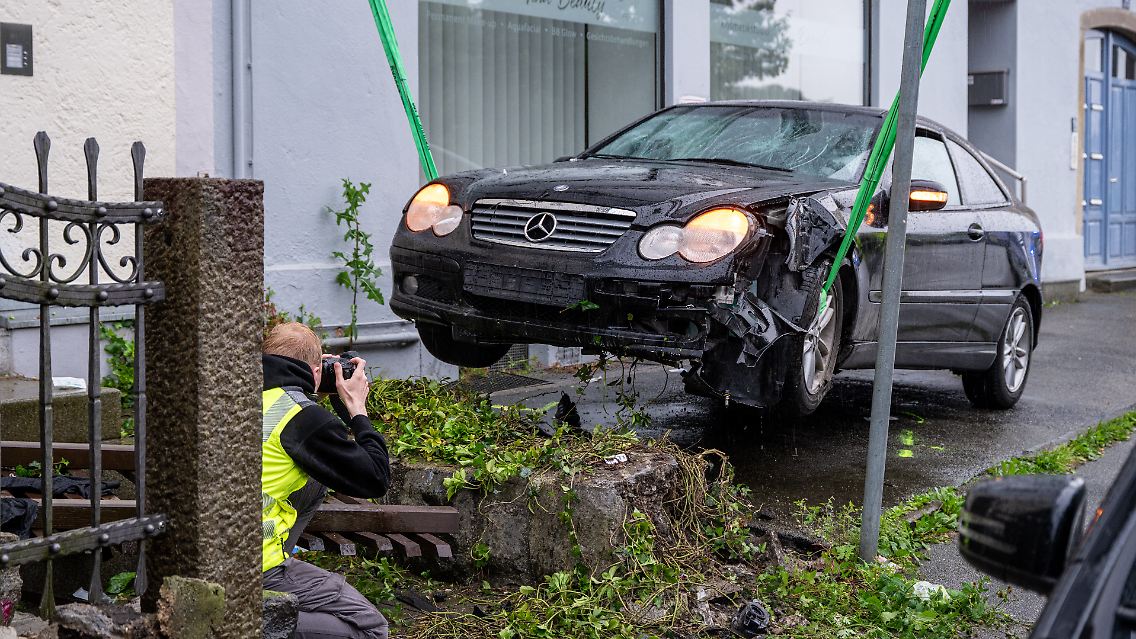 Das beschädigte Auto wird fotografiert.