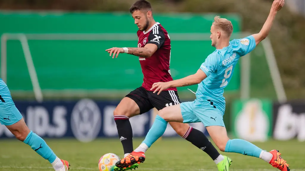 Nuernbergs-Erik-Shuranov-l-und-Kaan-Marienborns-Jannes-Hoffmann-kaempfen-um-den-Ball