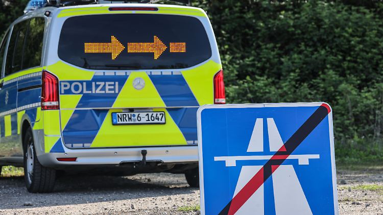 Ein Hinweisschild für eine gesperrte Autobahn steht beim Eigensicherungstag der Polizei Nordrhein-Westfalen vor einem Einsatzfahrzeug.