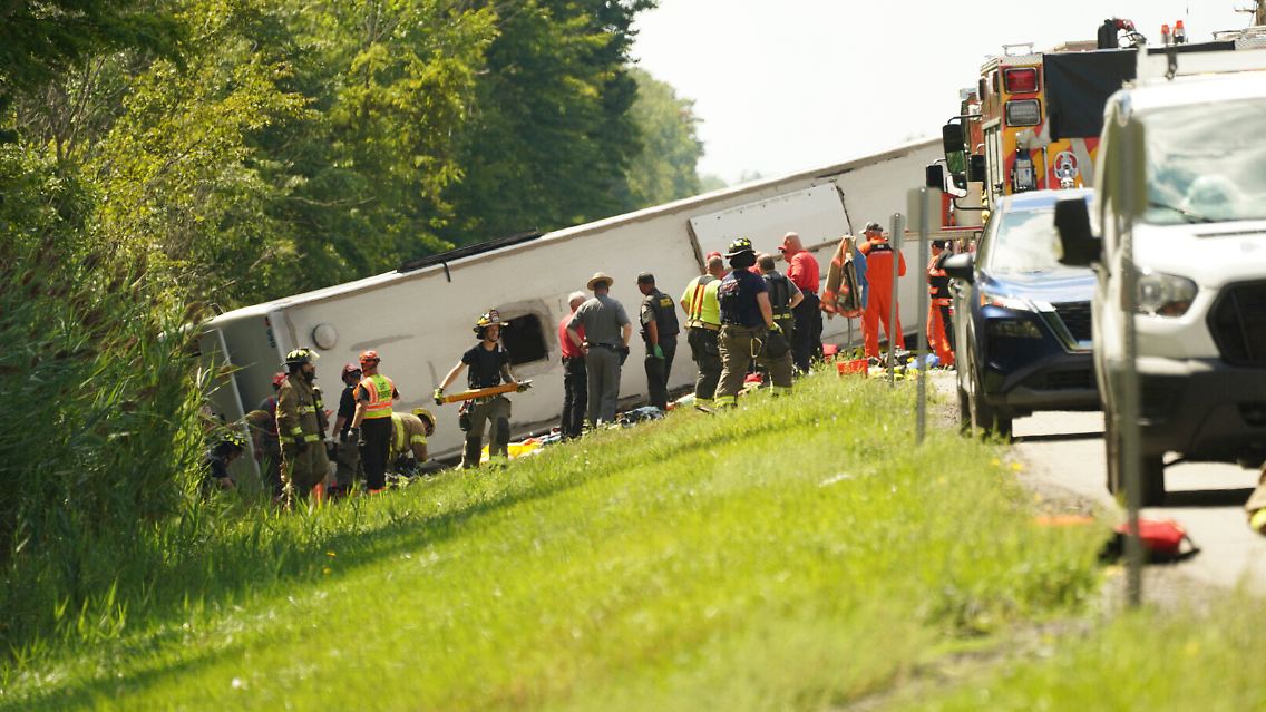Bilder vom Unfallort zeigen den verunglückten Bus auf der Seite liegend.