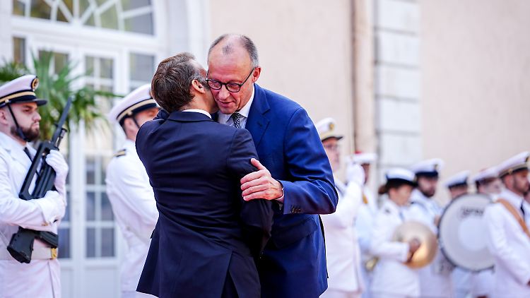 Macron und Merz üben in inniger Umarmung den Schulterschluss für die Ukraine. 