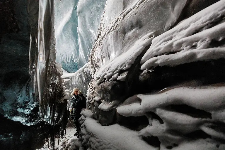 Vegard-Sand-looks-at-the-ice-walls-inside-a-glacier-cave-close-to-Kongsfjord