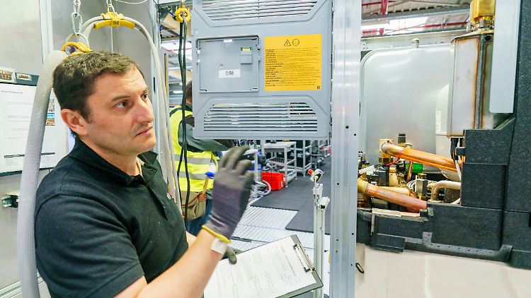 Ein Bosch-Mitarbeiter im hessischen Eschenburg kontrolliert einen Montageschritt einer Wärmepumpe. 