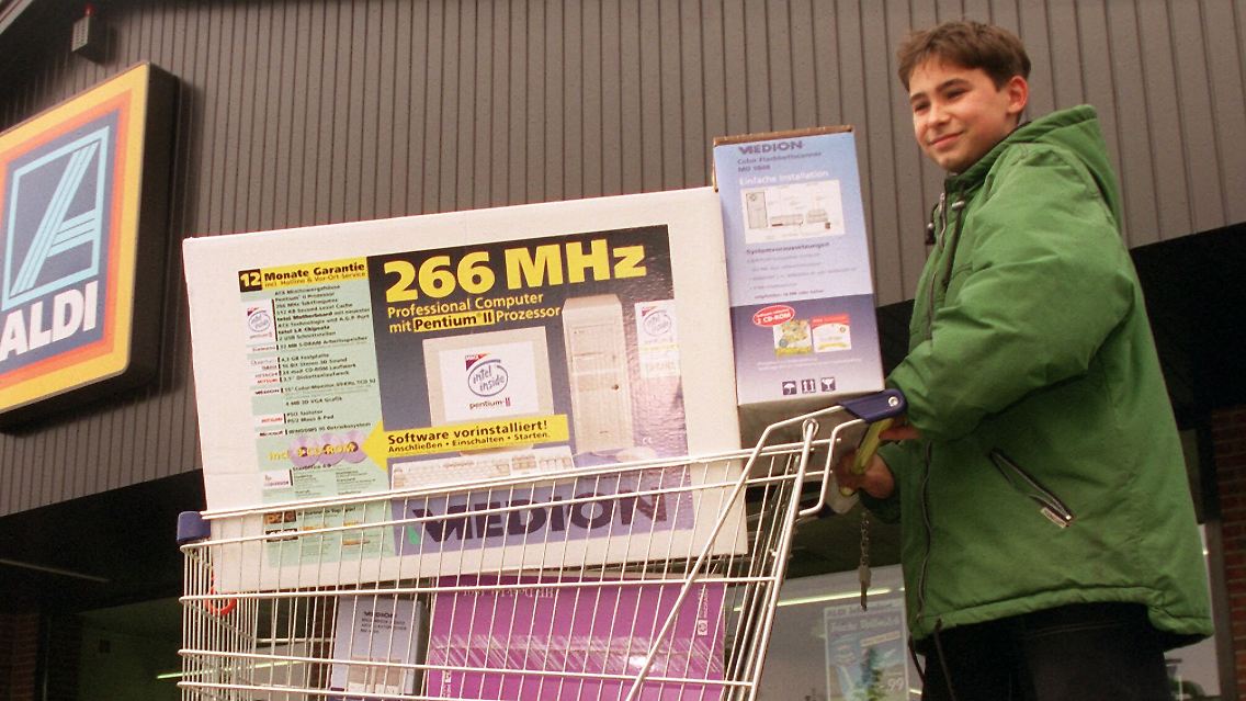 Ein Junge schiebt im Jahr 1998 einen Computer aus einer Aldi-Filiale. Kosten: 1998 Mark.