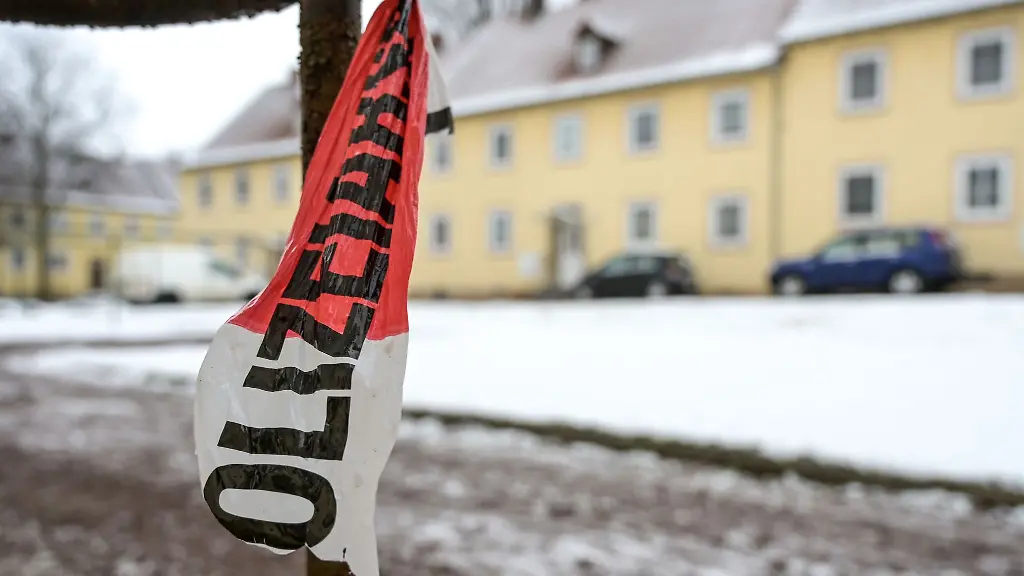 Absperrband-der-Polizei-ist-vor-einem-Wohnhaus-zu-sehen-Ein-60-jaehriger-Mann-und-eine-59-jaehrige-Frau-sind-laut-Polizei-durch-Schussverletzungen-in-ihrer-Wohnung-gestorben-Beim-Eintreffen-der-Polizeibeamten-schoss-der-Mann-aus-dem-Fenster-seiner-Wohnung-in-ihre-Richtung