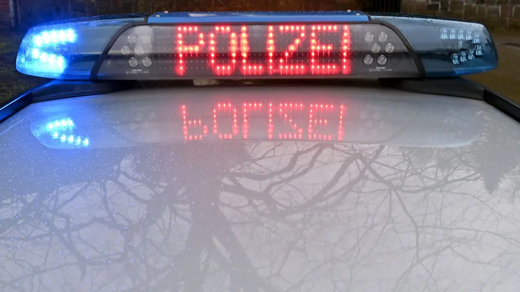 Die-Schriftzug-Polizei-leuchtet-auf-dem-Dach-eines-Streifenwagens-der-Polizei