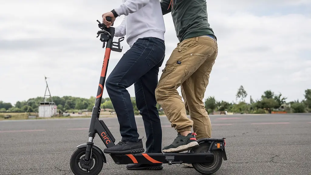 Doppelt-falsch-Zum-einen-sind-Mitfahrende-auf-E-Tretrollern-verboten-und-zum-anderen-koennen-sie-auch-als-Fahrer-gelten-sollten-sie-sich-am-Lenker-festhalte
