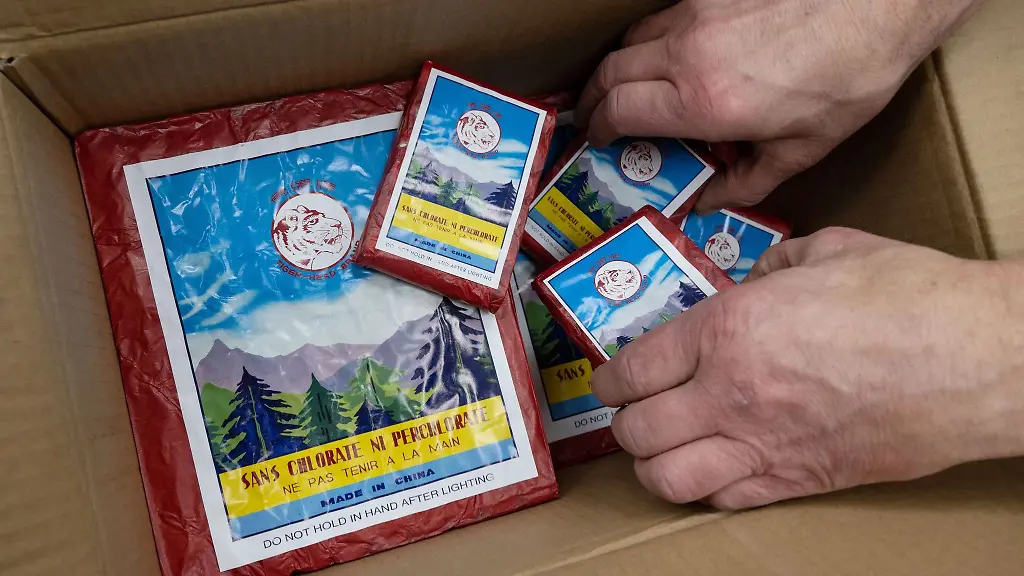 Ein-Mann-nimmt-Feuerwerkskoerper-aus-einem-Karton