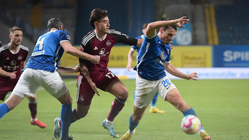 Rostocks-Lukas-Scherff-r-verteidigt-den-Ball-gegen-Nuernbergs-Jens-Castrop