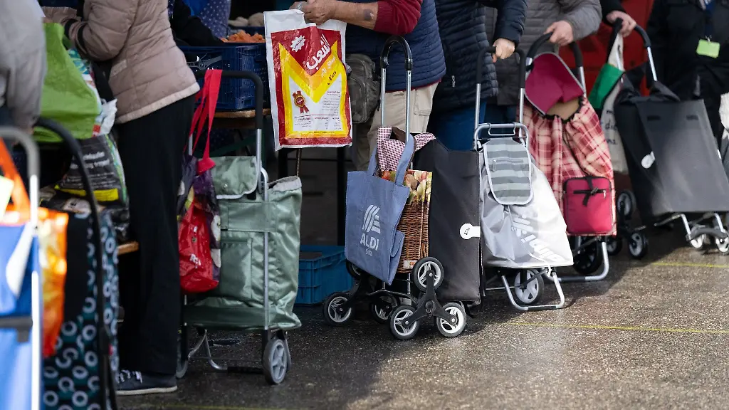 Gaeste-stehen-an-einer-Ausgabestelle-der-Tafel