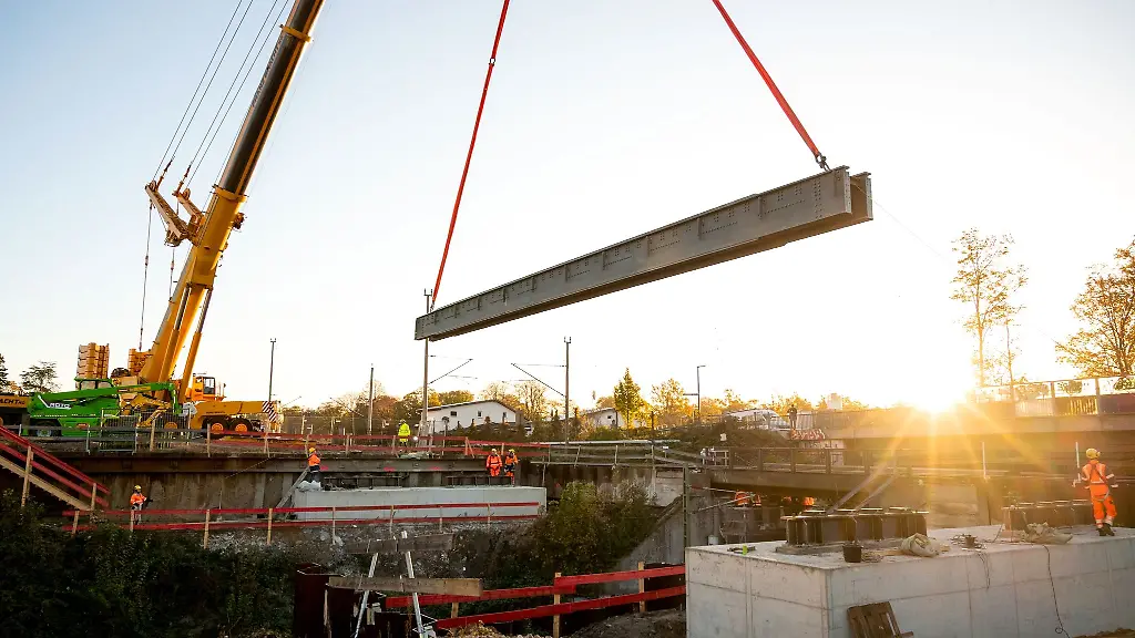 Teile-einer-Bruecke-werden-auf-der-Baustelle-der-neuen-S-Bahn-Linie-S4-im-Stadtteil-Marienthal-mit-einem-Kran-eingehoben