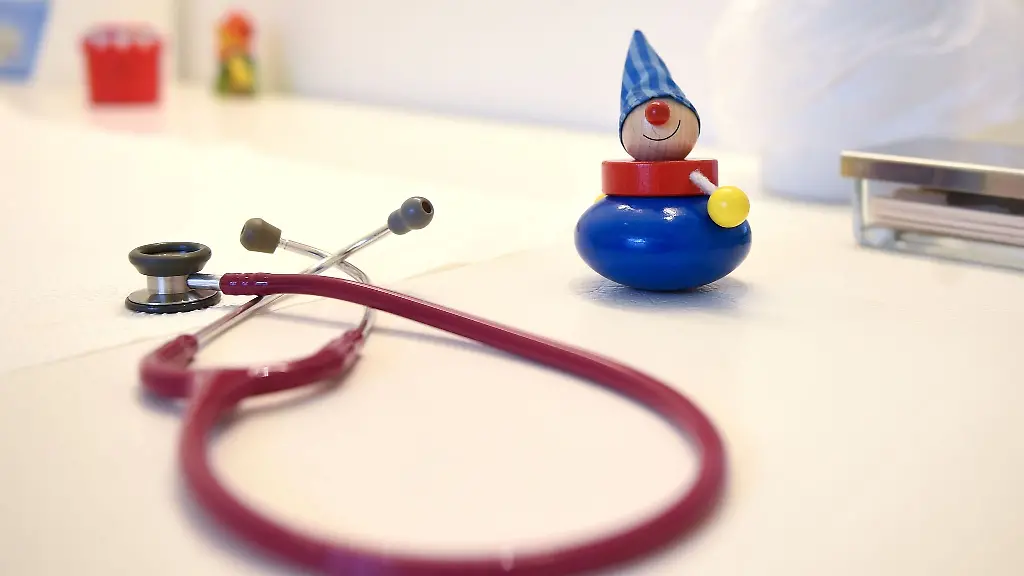 Ein-Stethoskop-und-Kinderspielzeug-liegen-in-einer-Kinderarztpraxis-auf-einem-Tisch
