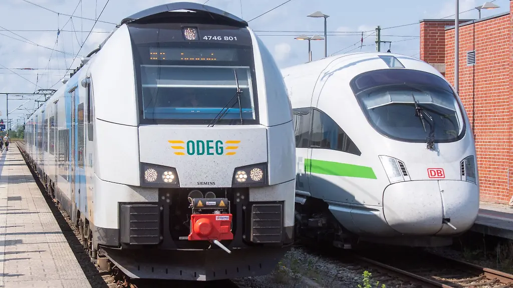 Ein-Regionalzug-der-ODEG-Ostdeutsche-Eisenbahn-GmbH-und-ein-ICE-der-Deutschen-Bahn-DB-stehen-im-Bahnhof