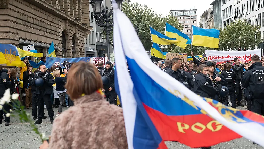 Eine-prorussische-Demonstrantin-steht-auf-dem-Opernplatz-vor-proukrainischen-Gegendemonstranten