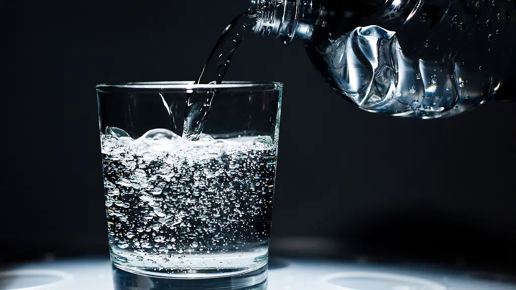 Ein-Glas-wird-mit-Mineralwasser-befuellt