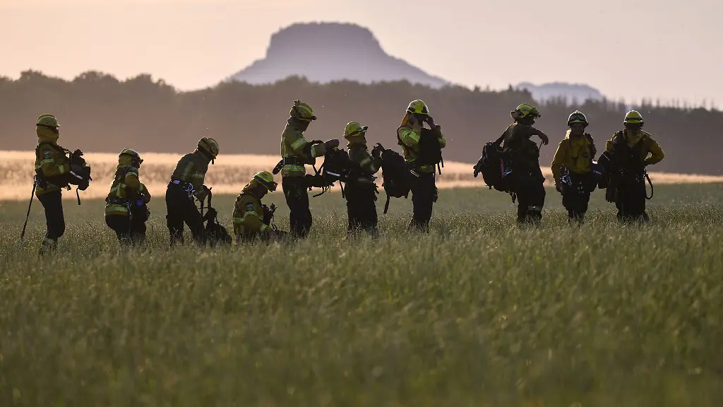 Freiwillige-Feuerwehrleute-des-Internationalen-Katastrophenschutz-Deutschland-fire-stehen-nach-dem-Einsatz-auf-einer-Wiese