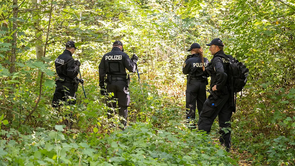 Polizisten-durchsuchen-ein-Waldstueck-in-dessen-Naehe-eine-weibliche-Leiche-in-einem-PKW-entdeckt-wurde