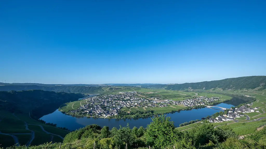 Wolkenfreier-Himmel-ist-am-Morgen-ueber-der-Moselschleife-und-dem-Weinort-Piesport