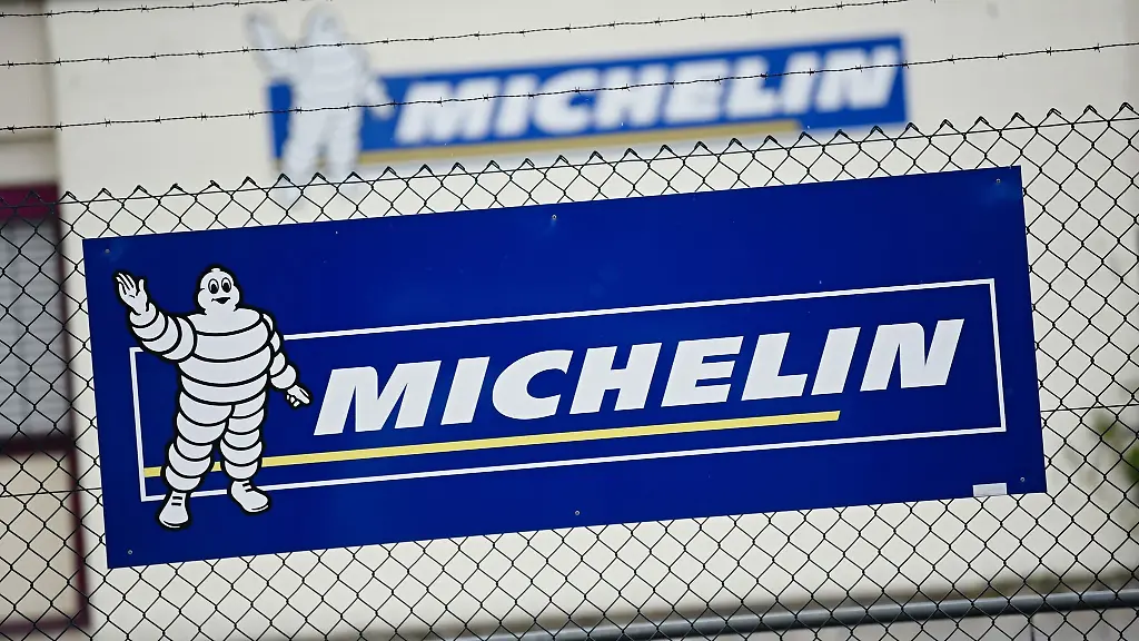 Vor-dem-Michelin-Werk-in-Hallstadt-ist-ein-Banner-mit-dem-Firmenlogo-an-einem-Zaun-zu-sehen