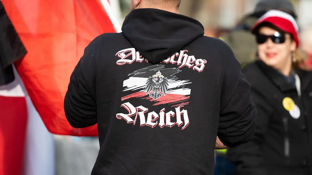Ein-Mann-traegt-einen-Pullover-mit-dem-Aufdruck-Deutsches-Reich