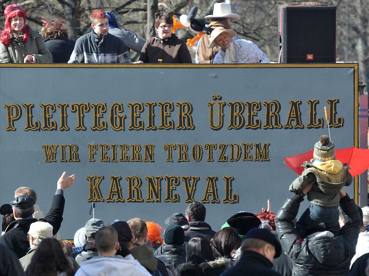 Narren ziehen mit einem Themenwagen durch Dessau.