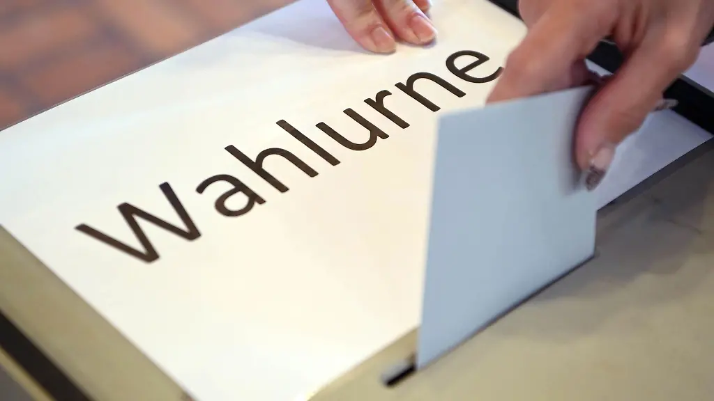 In-einem-Wahllokal-wird-ein-Stimmzettel-in-eine-Wahlurne-geworfen