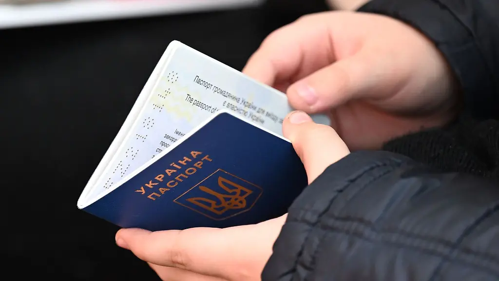 Ein-Maedchen-aus-der-Ukraine-haelt-in-einem-Aufnahmezentrum-in-Halle-Saale-ihren-Pass-in-der-Hand